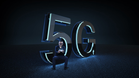 Businessman excited sit on the 3D render 5G futuristic font with blue neon light . Mobile network speed communication technology concept . Mixed media .の写真素材
