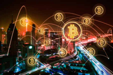 Bitcoins and blockchain network connection with blur night city background .Electronic money ,blockchain transfers and finance concept.の写真素材