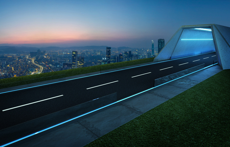 Empty asphalt road with tunnel ,greenfield and modern city skyline background . Mixed media .の写真素材