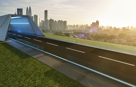 Empty asphalt road with tunnel ,greenfield and modern city skyline background . Mixed media .の写真素材