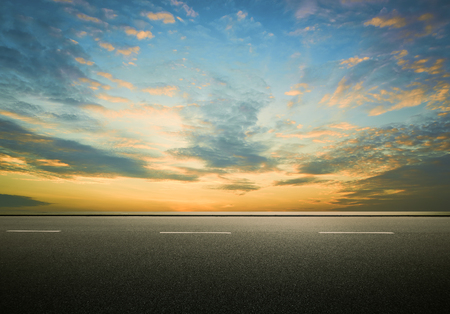 Asphalt road with dramatic sunrise sky , Horizontal format .の写真素材