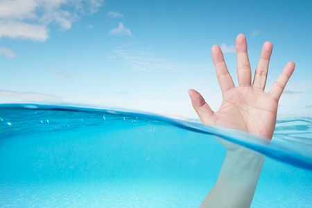 Waiting help hand in the waterの写真素材