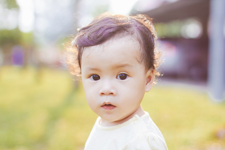 Portrait of cute and lovely curly hair asian chinese baby girl .の写真素材