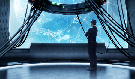 Young businessman watching global business plan in high tech control room big screen. Mixed media .の写真素材