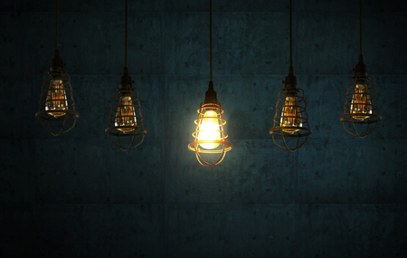 Hanging light bulb stand out from other bulb . Leadership, independence, initiative, strategy, dissent, think different, uniqueness ,business success concept .の写真素材