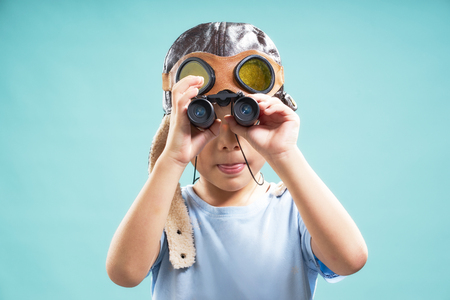 Little young cute asian boy using telescope looking forward .の写真素材