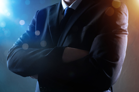Closeup business man with crossed arms with bokeh and light flare effect apply .の写真素材