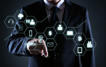 Businessman pressing the money icon on virtual screens ,business, technology and internet concept .の写真素材