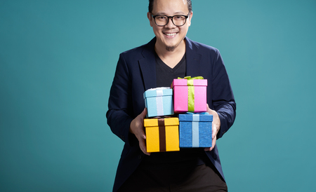 Businessman hold the present box to give somebody , holiday and christmas gift concept .の写真素材