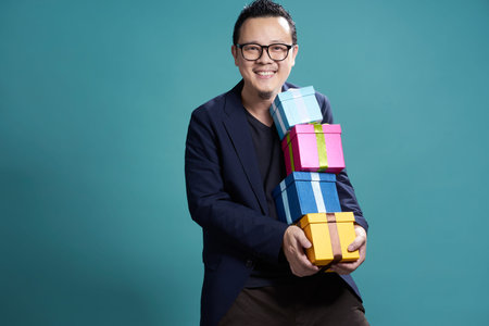Businessman hold the present box to give somebody , holiday and christmas gift concept .