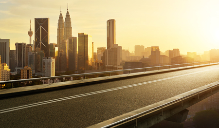 Empty asphalt flyover  road with modern cityscape skyline , sunrise scene .の写真素材
