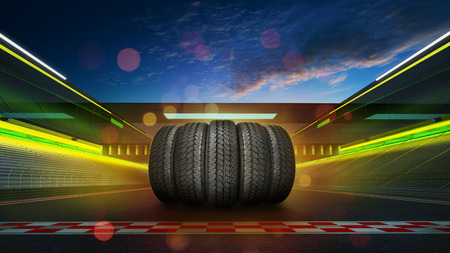 Car tires pile on a international race track with start and finish line, evening sceneの写真素材