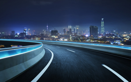 Highway overpass motion blur with city background . night scene .の写真素材