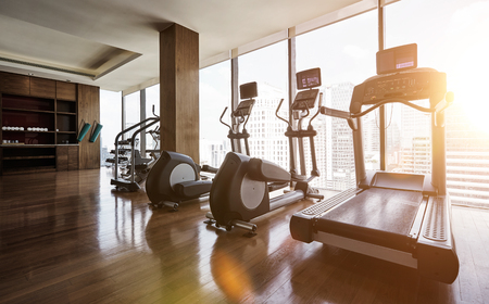 Modern gym room fitness center with set of treadmills staying in line , morning sunrise  scene .の写真素材
