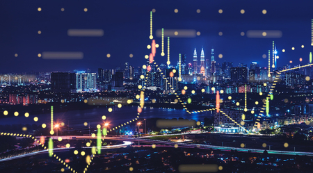 Beautiful Kuala Lumpur skyline at night with financial chart state blend in effect .の写真素材