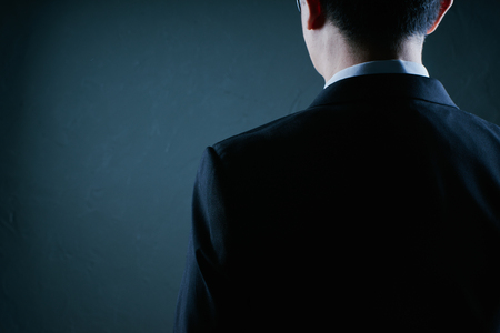 Businessman rear close up pose . Low key lighting .の写真素材
