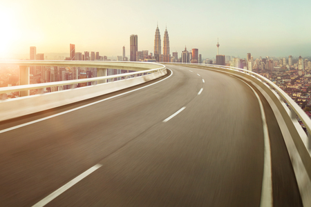 Highway overpass motion blur with city background .の写真素材
