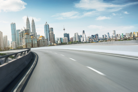 Highway overpass motion blur with city background .の写真素材
