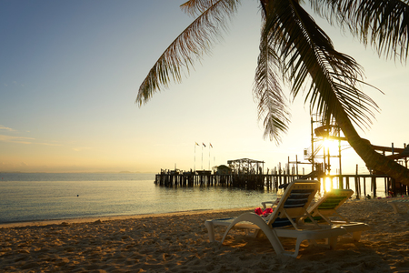 Couple of deck chairs at sunset on Rawa island , Summer travel concept, Malaysia .の写真素材