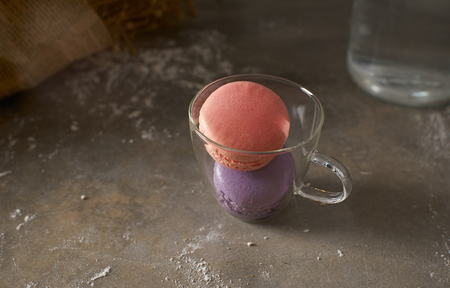 Pink and purple macarons on glass cup .の写真素材