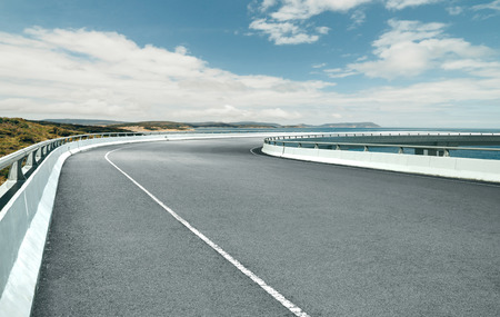 Curvy flyover highway asphalt road with with beautiful landscape , cloudy day .の写真素材