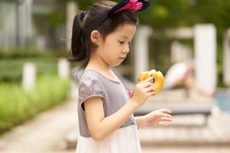 Delicious taste expression of little asian girl portrait .の写真素材