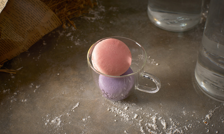 Pink and purple macarons on glass cup .の写真素材