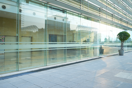 Modern glass facade business office building exterior with floorの写真素材