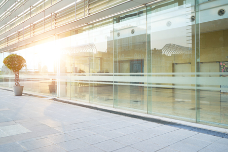 Modern glass facade business office building exterior with floorの写真素材