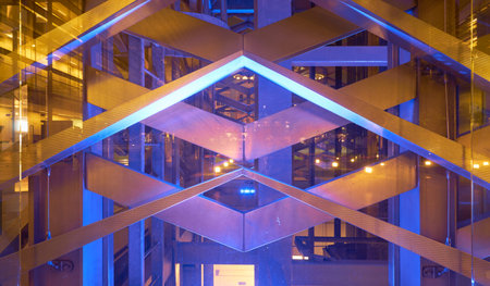 Abstract perspective background view of purple light office center building made of glass and steel...