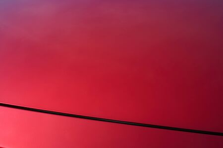 Close up of red metallic paint coating car bodyの写真素材