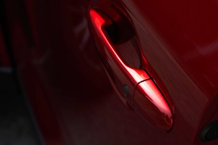 Close up of the door handle of a red carの写真素材