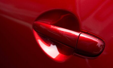 Close up of the door handle of a red carの写真素材