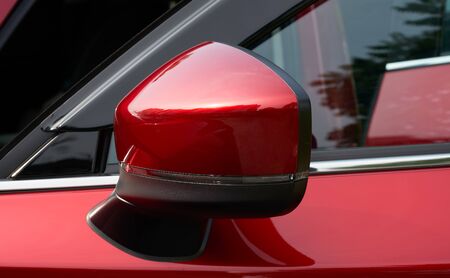 Close up of the side mirror of a red carの写真素材
