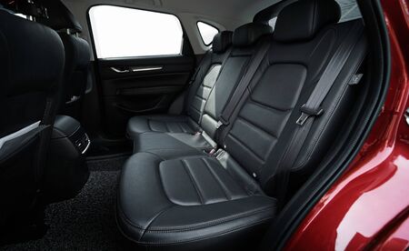 Closeup of a modern car interior with the black leather rear seats