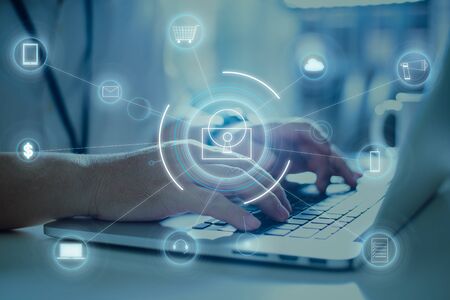 Businessman working at laptop with Internet and big data security protection concept .の写真素材