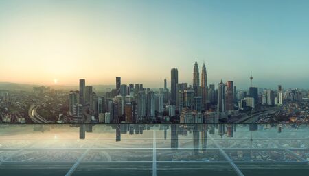 Modern empty transparent glass floor on rooftop with city skylineの写真素材