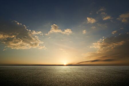 Beautiful sunset sky with empty asphalt floor .の写真素材