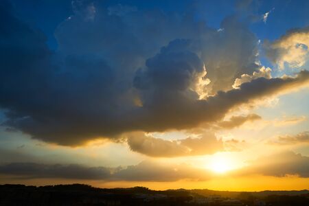 Beautiful vibrant golden and blue cloud dramatic sunset skyの写真素材