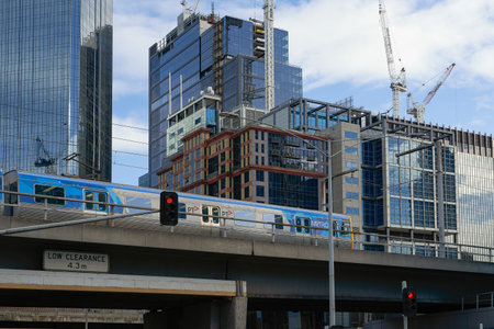 MELBOURNE, AUSTRALIA - OCTOBER 26,2019 : PT Metro Train running through in front of commercial...
