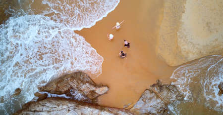 Aerial view of happy family enjoying on tropical beach, summer family vacation travel concept.の写真素材