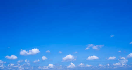 Beautiful and clean blue sky with fluffy white clouds, summer sky background.の写真素材