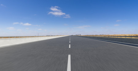 Centered perspective view of highway road with motion blur speed effect.