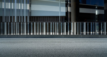 Side view of asphalt road with modern building exterior background