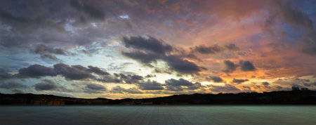Empty tiles floor with dramatic suset skyの写真素材