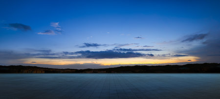 Empty tiles floor with dramatic suset skyの写真素材