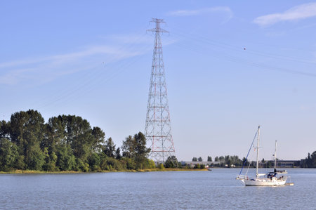 high voltage power lines and pylon across river and island