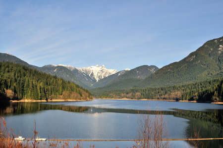 reservoir surrounded by mountainsの写真素材