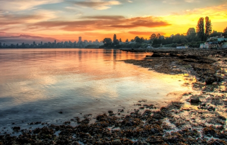 This vivid sunrise over Vancouver with the bay in the foreground is a beautiful landscape の写真素材