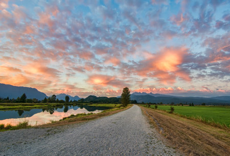 Amazing clouds above gravel path 